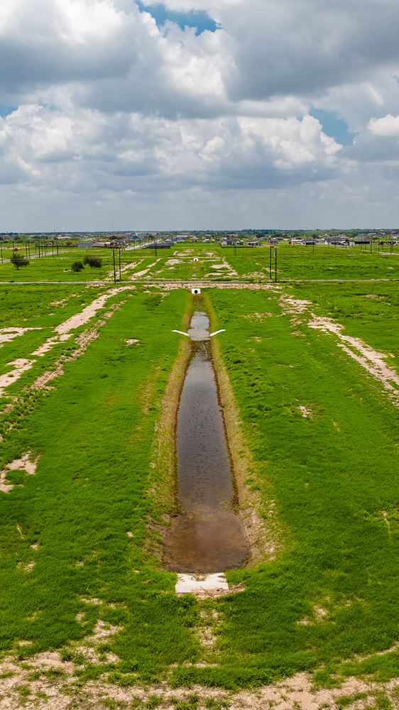 Drainage canal running past the lots
