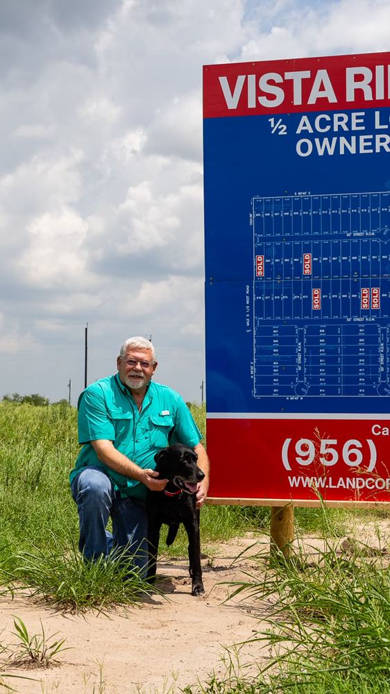 David, the seller, at the Vista Ridge Acres property sign